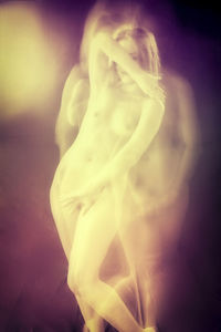 Digital composite image of woman against illuminated background