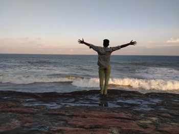 Rear view of man standing on beach