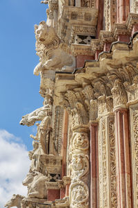  gargoyles and saints on the facade of siena cathedral