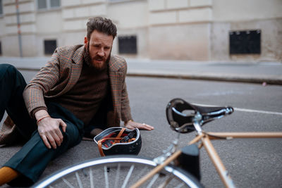 Portrait of man riding bicycle on street