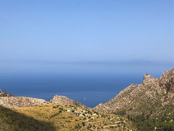 Panoramic view of sea and mountains against sky