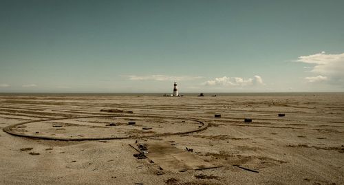 Man standing on beach against sky