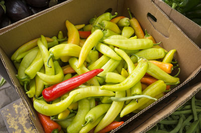 High angle view of jalapeno peppers in cardboard box for sale at market