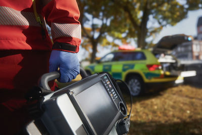 Emergency medical service. paramedic hand in surgical gloves while running with defibrillator.