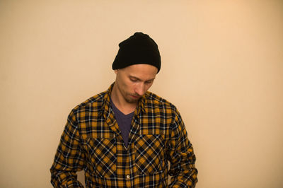 Young man looking away against white background