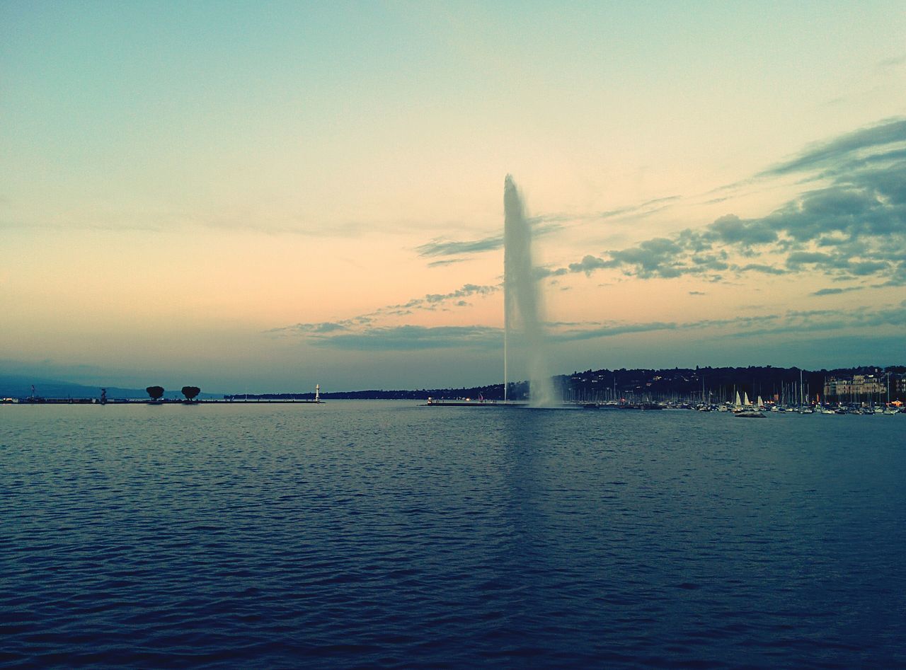 architecture, built structure, water, famous place, sky, international landmark, travel destinations, building exterior, tourism, waterfront, city, sea, travel, capital cities, sunset, river, tower, cloud - sky, bridge - man made structure, connection