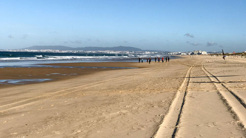 People on beach against sky