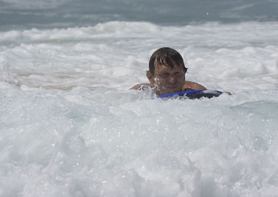 Man surfboarding in sea