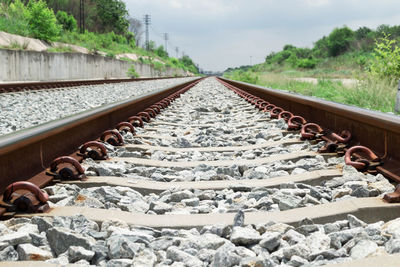 Surface level of railroad tracks against sky