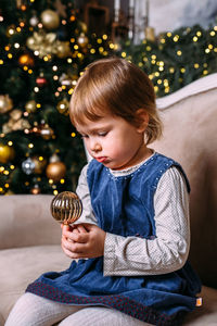 Little child at home for christmas with gifts