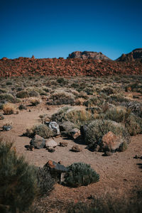 Scenic view of desert against clear blue sky