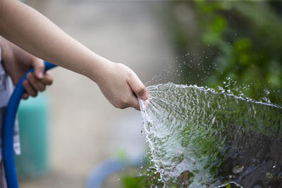 Close-up of hand holding water splashing