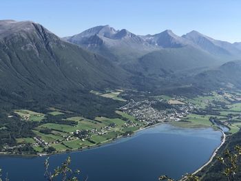 Scenic view of lake and mountains against clear sky