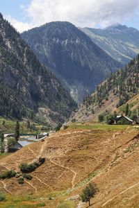 Scenic view of landscape and mountains against sky