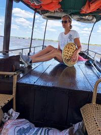 Woman sitting in boat on river