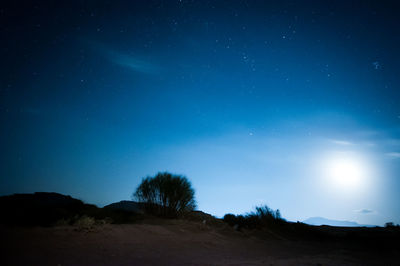 Low angle view of silhouette landscape against sky at night