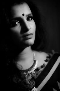 Close-up portrait of young woman at home