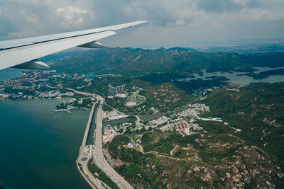 Aerial view of sea and mountains against sky