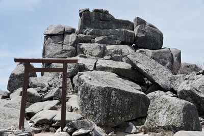 Low angle view of old stone wall against sky
