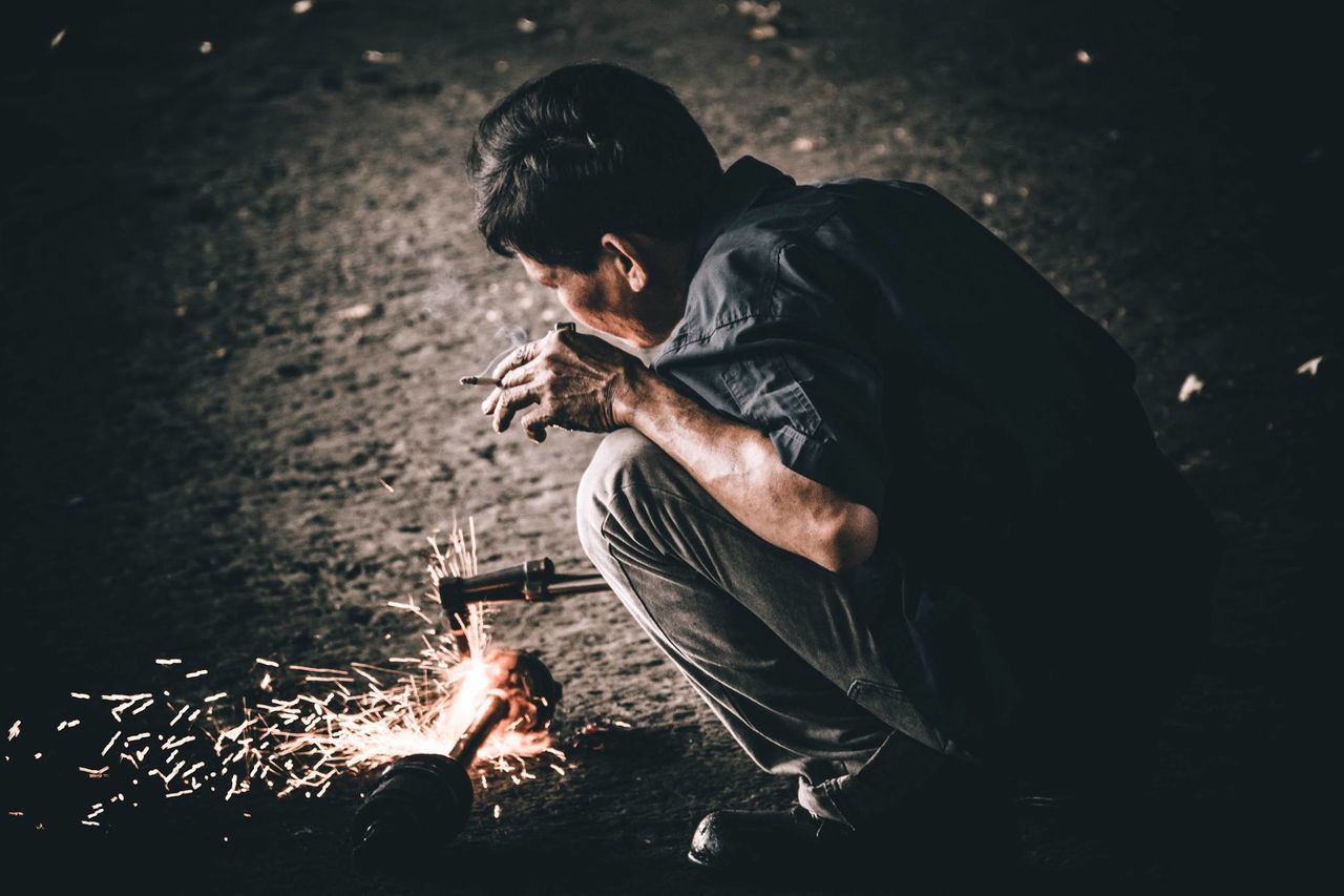 MAN AND WOMAN WITH FIRE ON BONFIRE