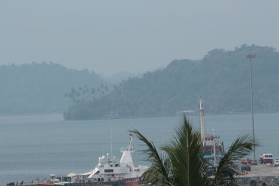 Scenic view of sea and mountains against sky