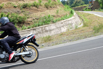 Man riding motorcycle on road