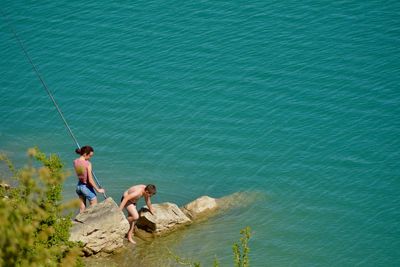 High angle view of men in sea