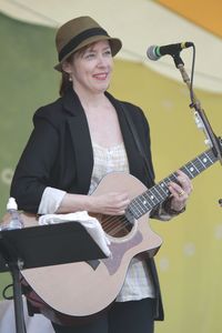 Full length of a smiling young man playing guitar