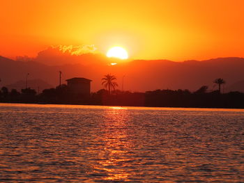 Scenic view of sea against orange sky