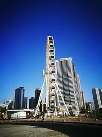 Low angle view of skyscrapers against blue sky