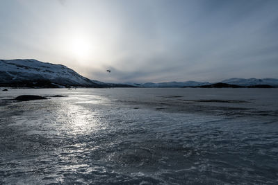 Scenic view of frozen lake against sky