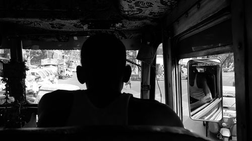 Rear view of man sitting in train