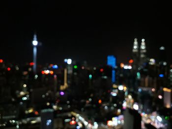 Defocused image of illuminated city buildings at night