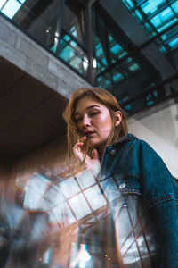 Portrait of beautiful young woman standing outdoors