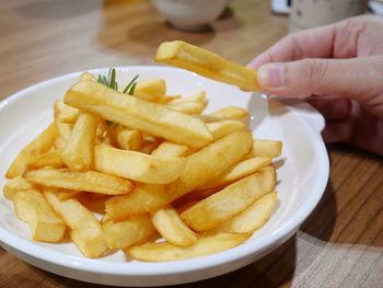 High angle view of hand holding food on table