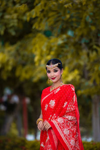 Portrait of smiling young woman standing outdoors