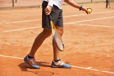 Low section of man playing tennis