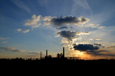 Silhouette factory against sky during sunset in duisburg 