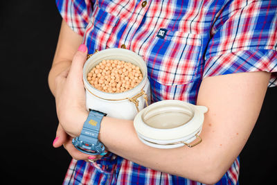 Midsection of woman holding drink