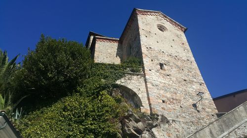 Low angle view of building against clear blue sky