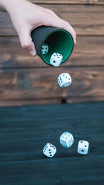 Close-up of pouring dices on table