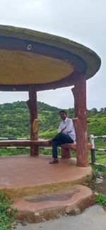 Man standing on field against sky