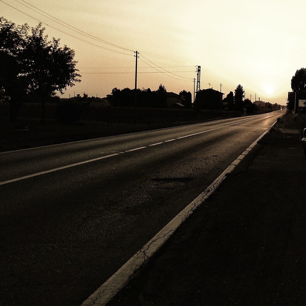 transportation, road, the way forward, clear sky, diminishing perspective, street, road marking, vanishing point, tree, sky, landscape, empty road, country road, asphalt, tranquility, silhouette, sunset, tranquil scene, empty, copy space