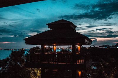 Illuminated house against sky at night