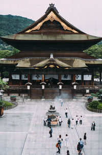 Group of people outside temple building