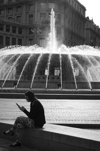 Man splashing water fountain