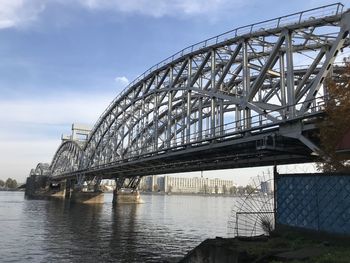 Low angle view of bridge over river against sky