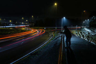 Light trails on road in city at night