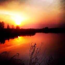 Scenic view of lake at sunset