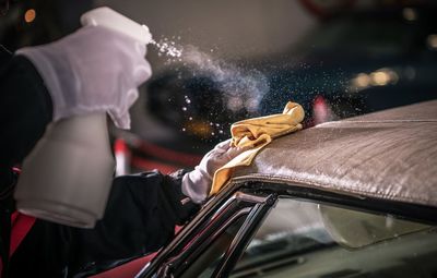 Close-up of man washing car